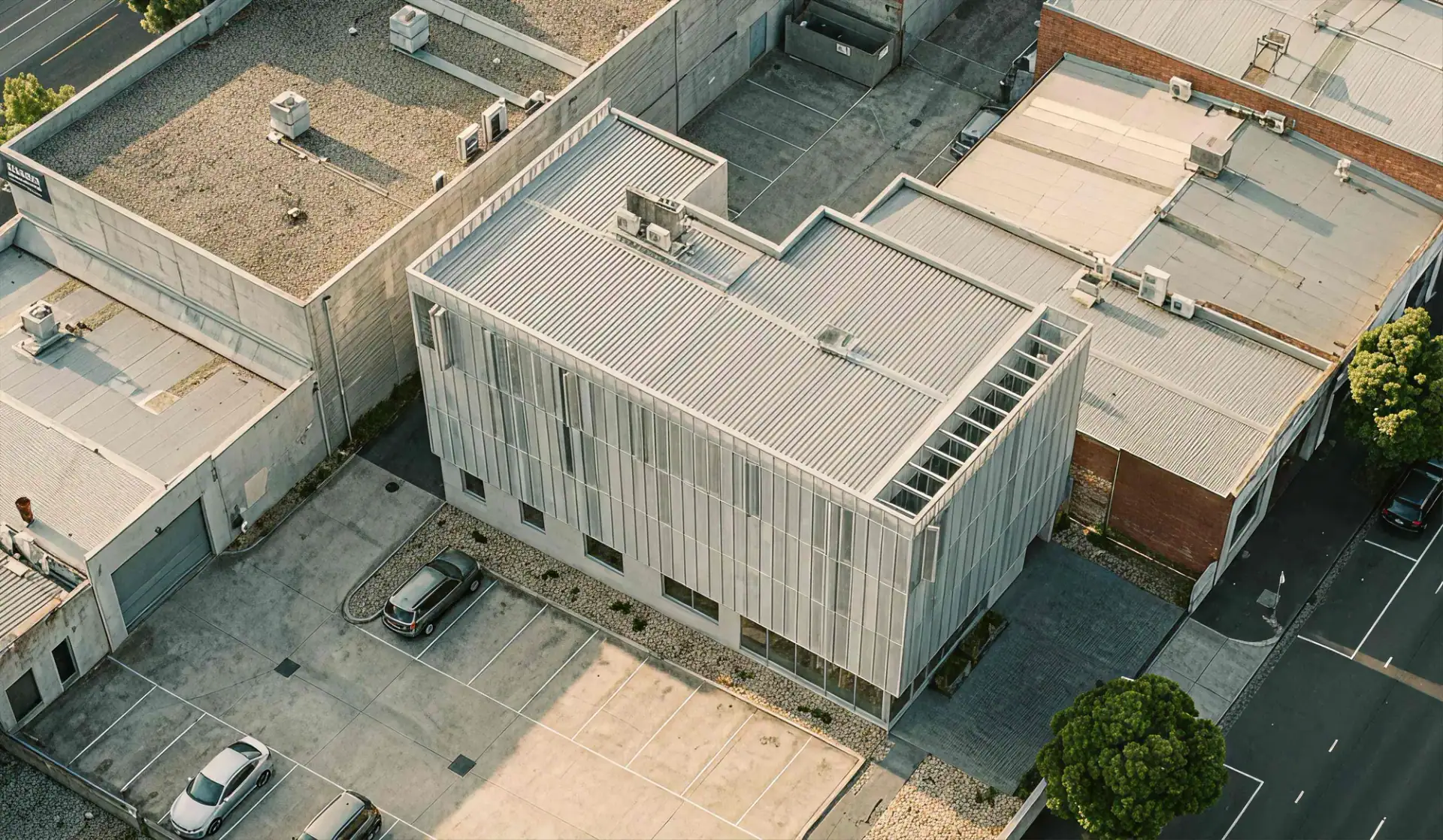 Aerial view of a commercial building and the surrounding properties